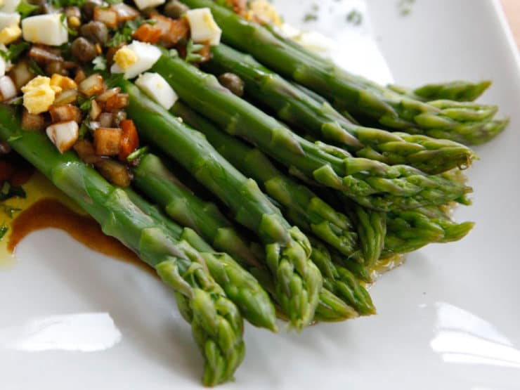 Marinated asparagus topped with chopped vegetables