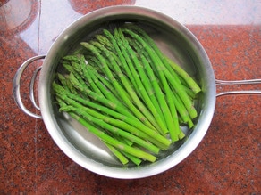 Asparagus in cold water to blanch.