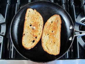 Toasting bread in a skillet.
