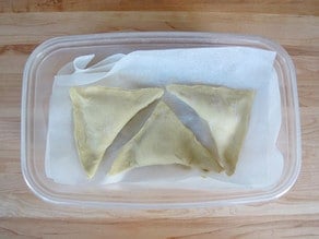 Freeze unbaked bourekas in layers of parchment.