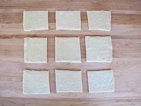 Puff pastry cut into nine squares.