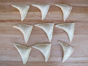 Folded pastries on a board.