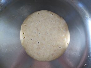 Bubbles rising to surface of pancake batter before turning.
