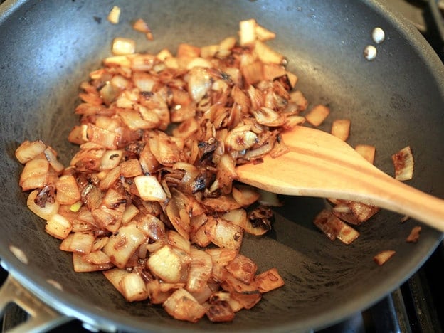 Browning mushrooms in a skillet.