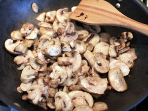 Sliced mushrooms added to skillet.