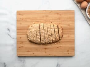Horizontal overhead shot of sliced mandel bread on a wooden cutting board.