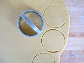 Cutting dough circles out.