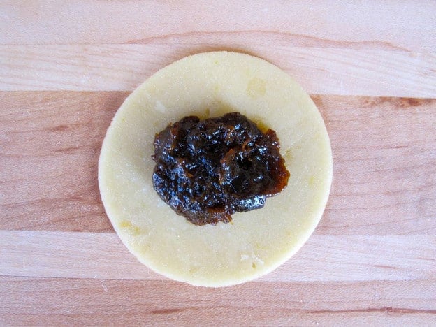 Filling placed in center of dough circle.
