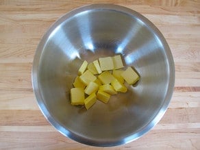 Sliced butter in a mixing bowl.