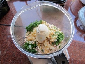 Chicken and seasoning in a food processor.