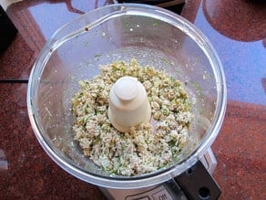 Chicken and seasoning in a food processor.