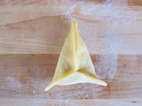 Dough pinched into three corners.