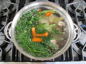 Vegetables added to boiling chicken.