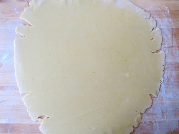 Dough rolled out on a floured surface.