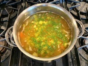 A pot of Matzo Ball Soup simmering on the stove