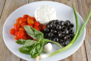 Caprese ingredients in a large bowl.