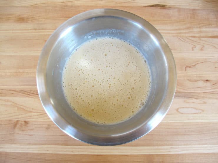 Milk whisked into dry ingredients in a bowl.