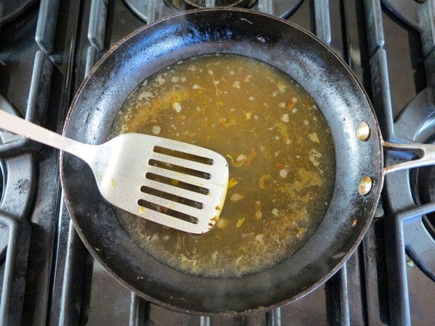 Scraping fond from the skillet.