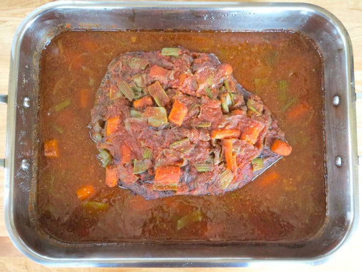 Cooked brisket in roasting pan.