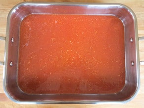 Tomato marinade in a roasting pan.