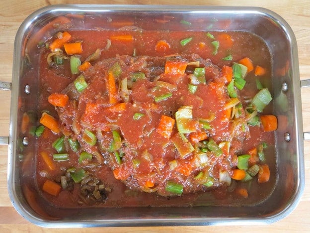 Last of tomato marinade poured over brisket.