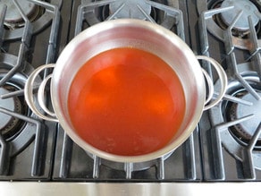 Preparing sweet sour sauce in a saucepan.