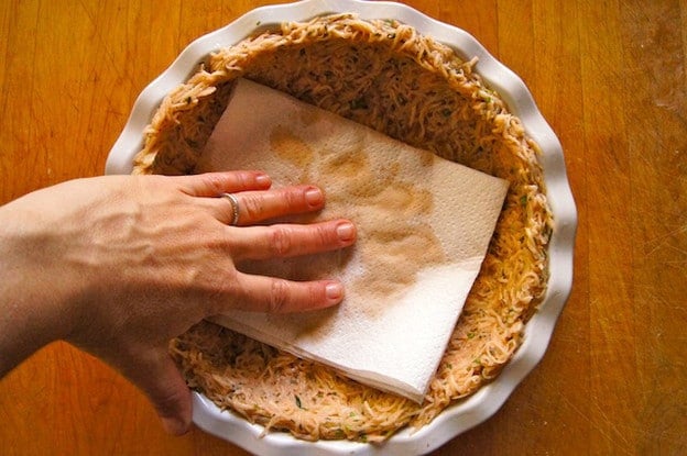 Blotting potato crust with paper towel.