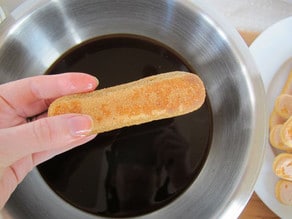 Dipping ladyfingers in coffee.