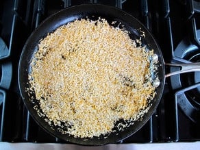 Dry toasting shredded coconut in a skillet.