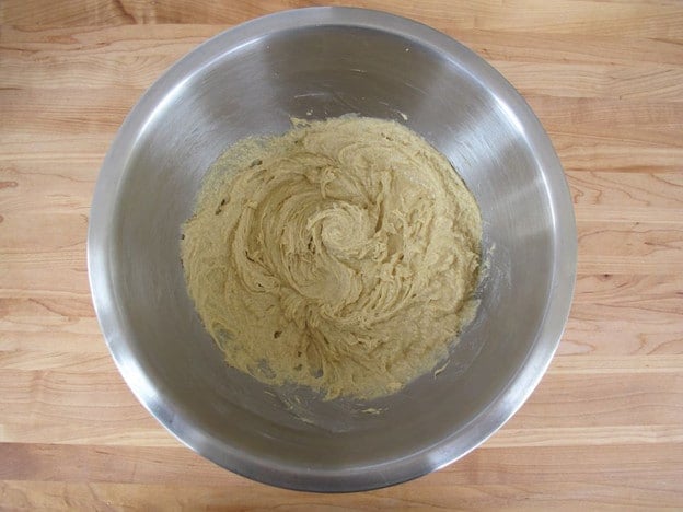 Eggs beaten into butter in a bowl.
