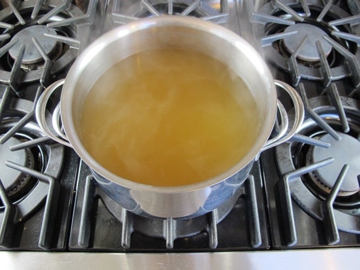 Pot of Court Bouillon - Steaming hot, barely boiling, on stovetop.