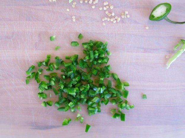 Diced jalapeno on a cutting board.