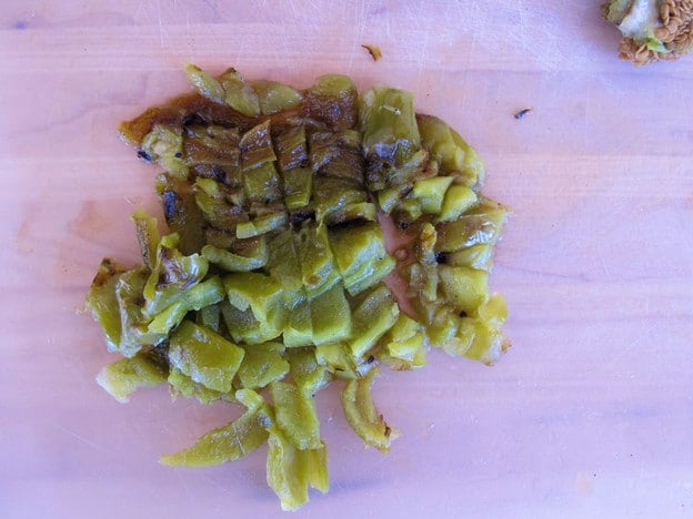 Roasted, diced peppers on a cutting board.
