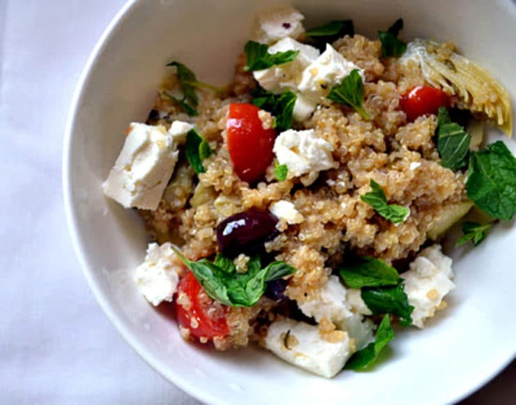 Greek Infused Quinoa Salad - A gluten free vegetarian salad with quinoa for protein, fresh oregano, olives, tomatoes, artichokes and lemon zest. Kosher for Passover, dairy.