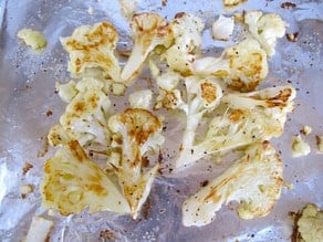 Roasted cauliflower on a baking sheet.