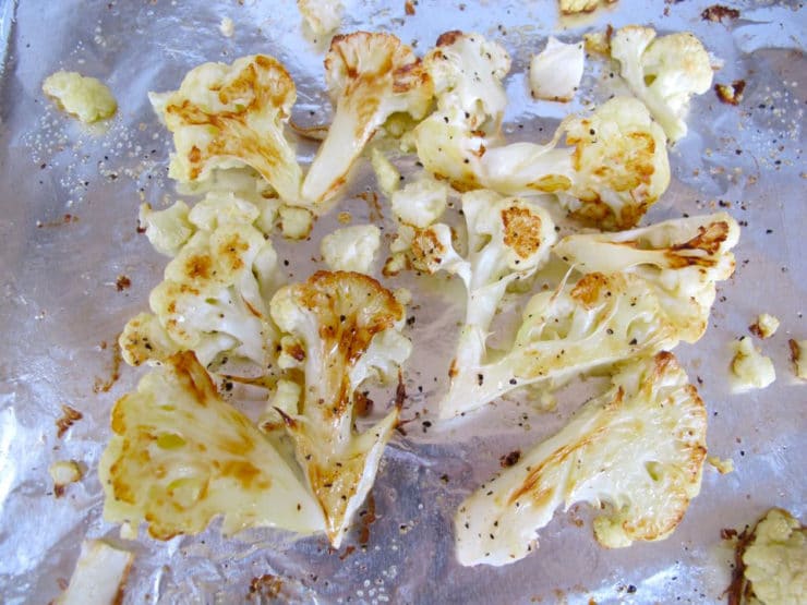 Roasted cauliflower on a baking sheet.