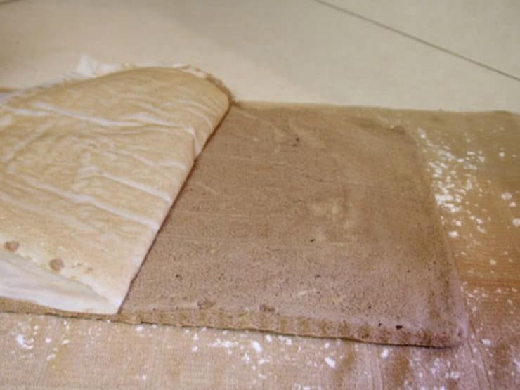 Peeling parchment off baked cake.