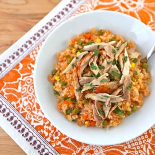 Mexican Arroz con Pollo- tomato vegetable rice, garlic and onion slow cooked with tender chicken. Easy healthy affordable one pot meal