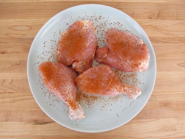 Seasoning chicken parts.