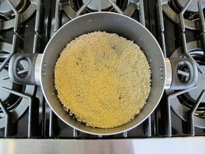 Sauteeing rice in a skillet.