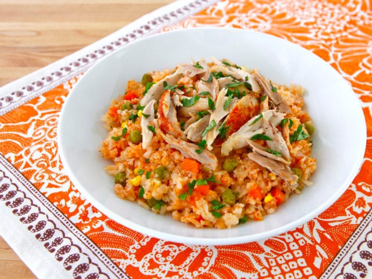 Mexican Arroz con Pollo- tomato vegetable rice, garlic and onion slow cooked with tender chicken. Easy healthy affordable one pot meal