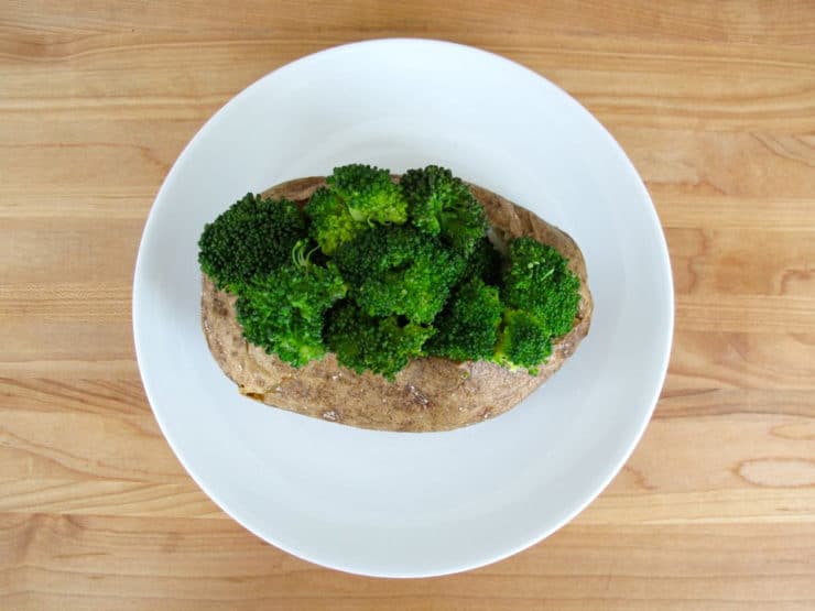 Cooked broccoli stuffed into baked potato.