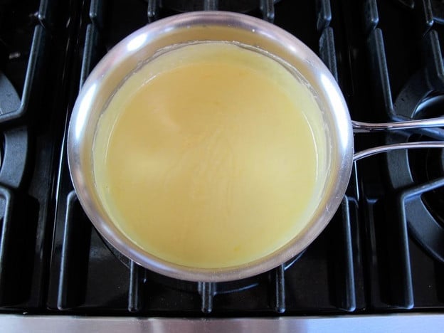 Whisking cheese into milk.