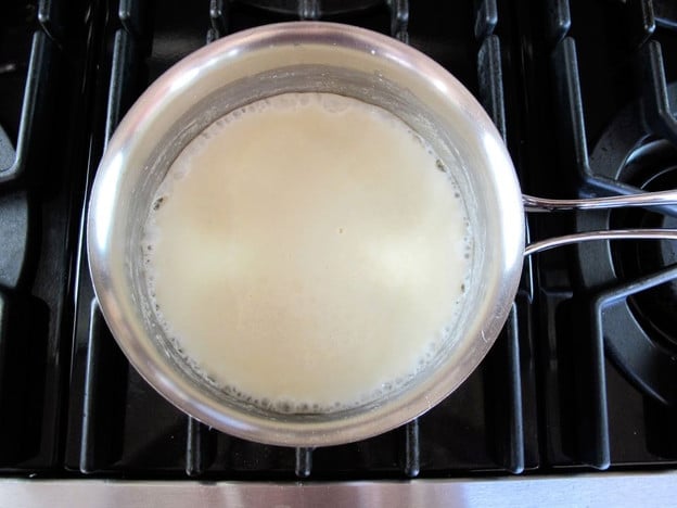 Whisking milk into roux.