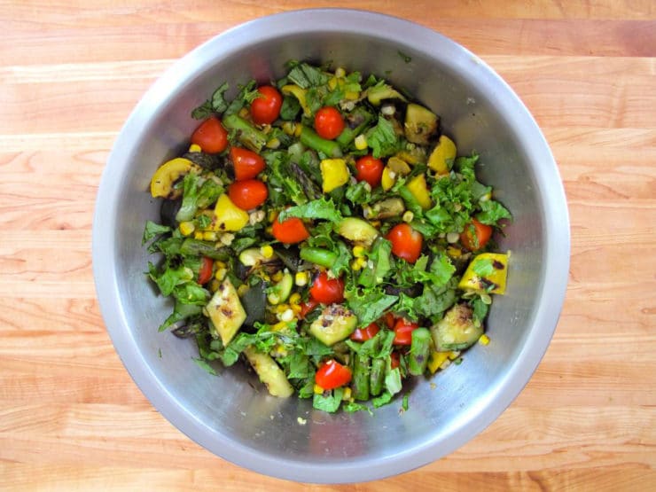 Grilled vegetables tossed in a salad bowl.