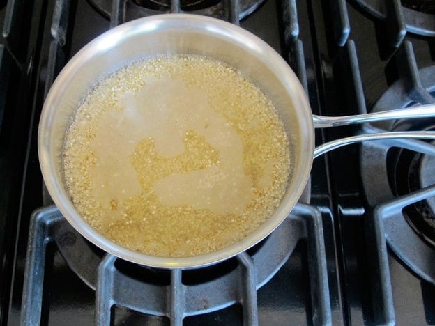 Cooking quinoa in a saucepan.