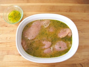 Chicken marinating in a baking dish.