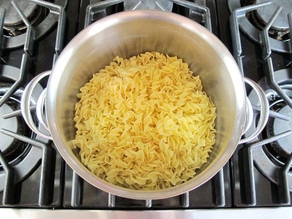 Cooked noodles in a stockpot.