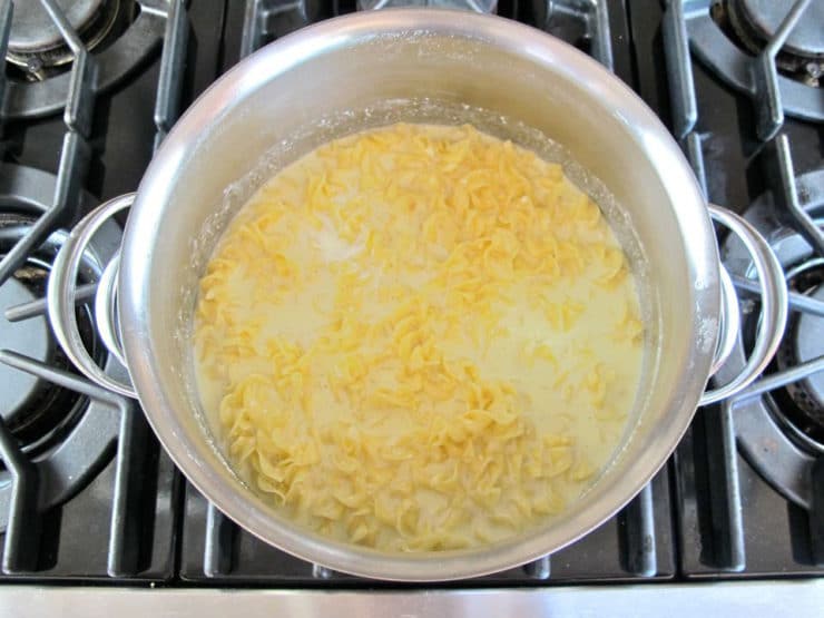 Egg mixture stirred into pot of noodles.
