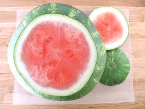 Slicing the ends off a seedless watermelon.